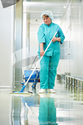 Image of Woman cleaning hospital hall