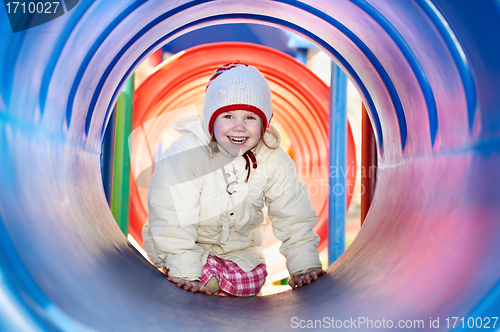 Image of laughing little baby girl in tube