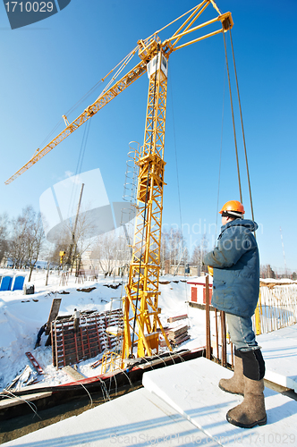 Image of worker with tower crane remote control equipment