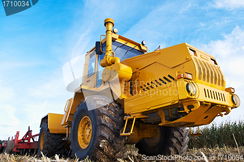 Image of Ploughing tractor at field cultivation work