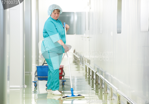 Image of Woman cleaning hospital hall