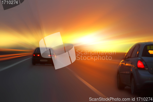 Image of car at sunset on the highway