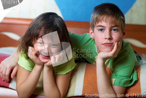 Image of Children lying on their bellies in a bedroom