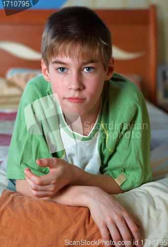 Image of calm boy  alone in bed