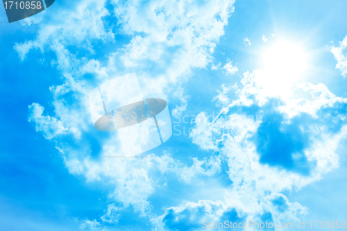 Image of Blue sky with clouds and sun