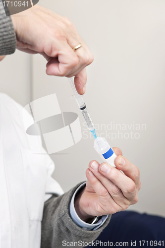Image of Doctor Filling Syringe For Vaccination