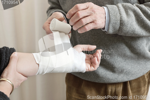 Image of Doctor Applying Bandage On Injured Hand