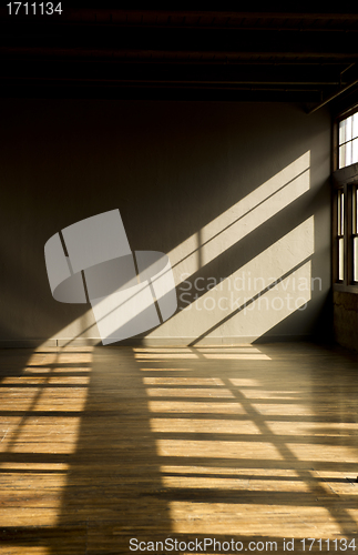 Image of Late day window light streaming thru windows into vacant loft