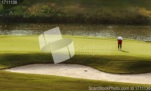 Image of Golfer putting on green