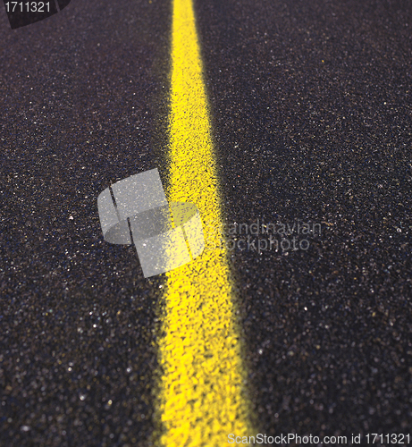 Image of Asphalt road texture with yellow stripe