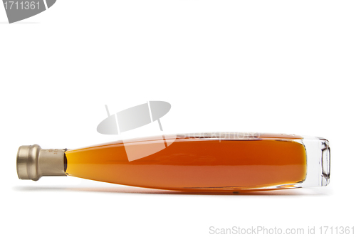 Image of Alcohol cognac in a closed bottle on white background