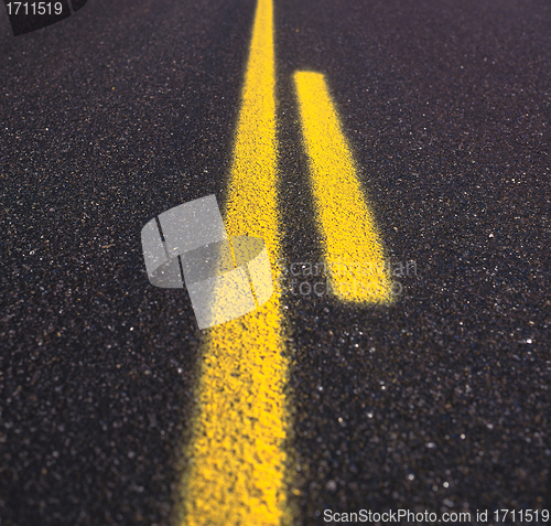 Image of Asphalt road texture with yellow stripe