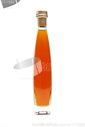 Image of Alcohol cognac in a closed bottle on white background