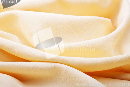 Image of background of bright yellow silk with waves