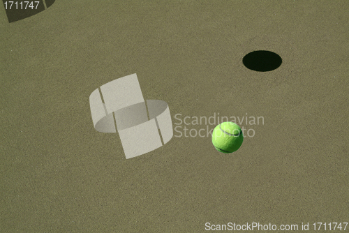 Image of lonely Tennis Ball on a Sand Court