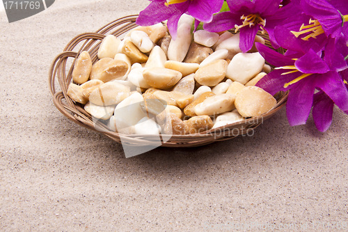 Image of stones with flowers on beach