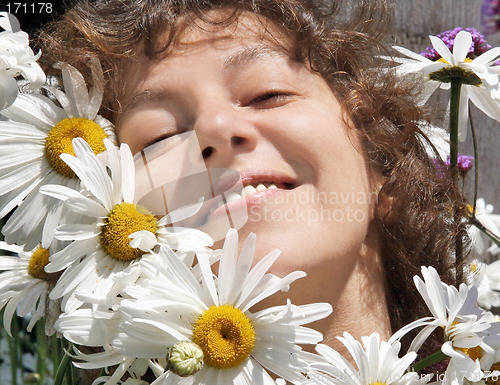 Image of Smiling woman with daisies