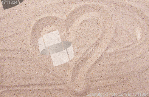 Image of heart drawing on sea sand