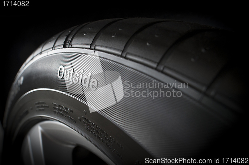 Image of New tire from side with outside text
