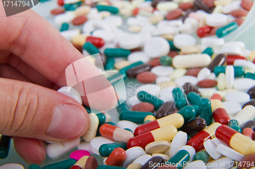 Image of hand grabbing pills