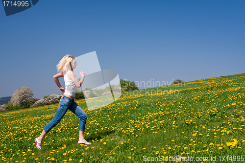 Image of happy young woman on meadow