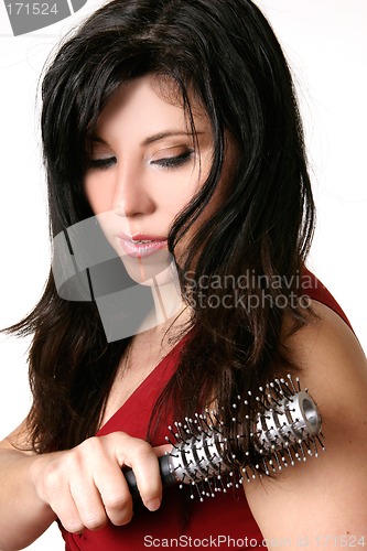 Image of Beautiful woman brushing her hair