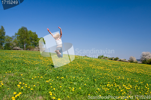 Image of happy young woman on meadow