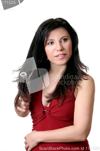 Image of Female brushing her hair