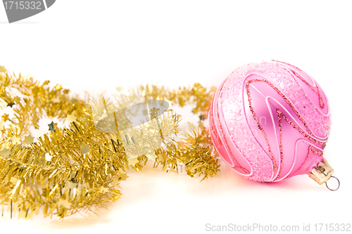 Image of golden tinsel with pink glass decoration