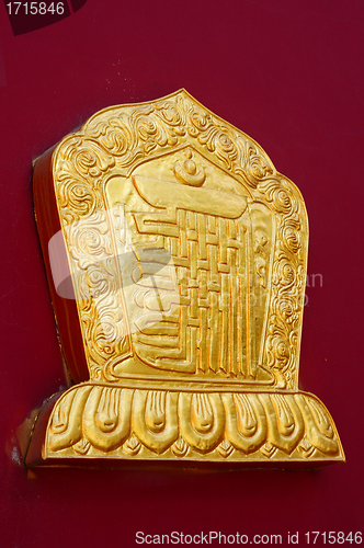 Image of Golden decoration on a lamasery's red wall