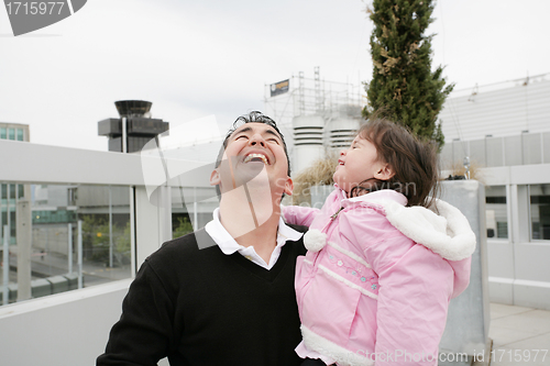 Image of Father and daughter happy looking up outdoors