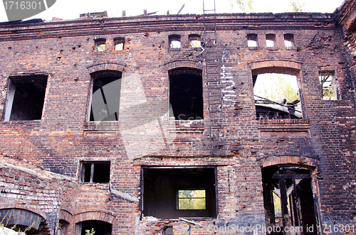 Image of old abandoned building after fire. ladders windows 
