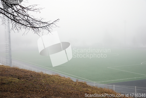 Image of football field in thick fog in the morning