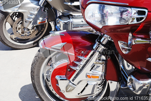 Image of motor cycle engine and bike reflected in a chromium-plated surfa