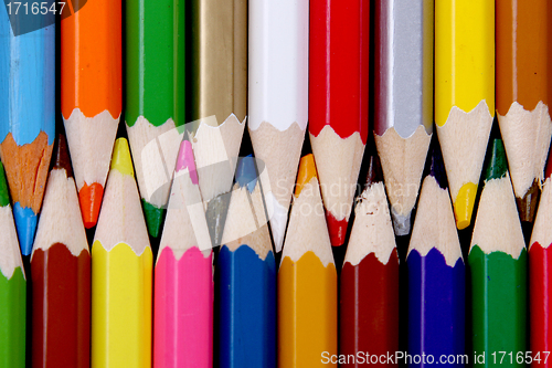 Image of Assortment of coloured pencils with shadow on white/back backgro