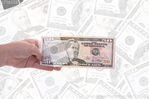 Image of hand holding a dollar bill, business studio photo