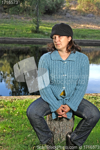 Image of  beautiful woman in an autumn park 