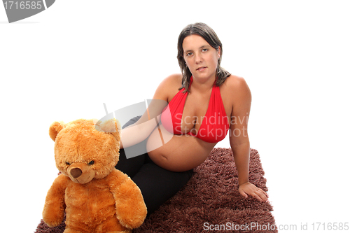 Image of beautiful pregnant woman with beautiful belly and teddy bear