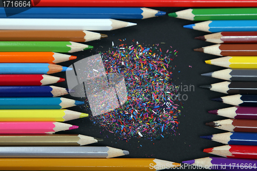 Image of Assortment of coloured pencils with shadow on white/back backgro