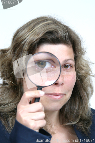 Image of Young businesswoman holding Magnifying Glass, business photo