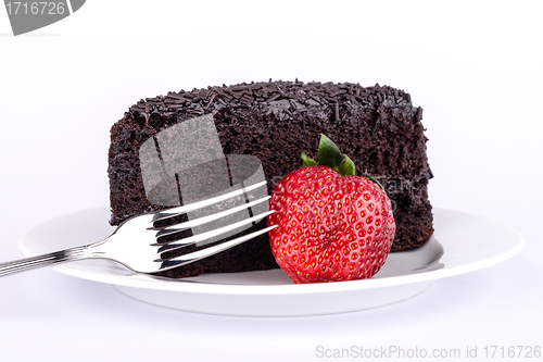 Image of Slice of chocolate cake with strawberries.