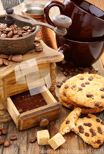 Image of Coffee Mill, cups and biscuits.