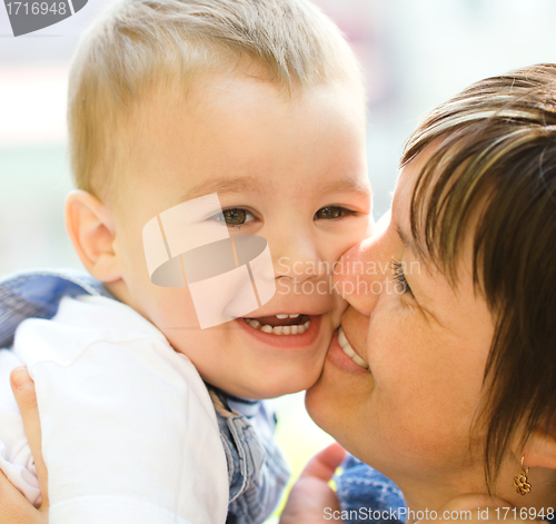 Image of Portrait of a mother hugging her son