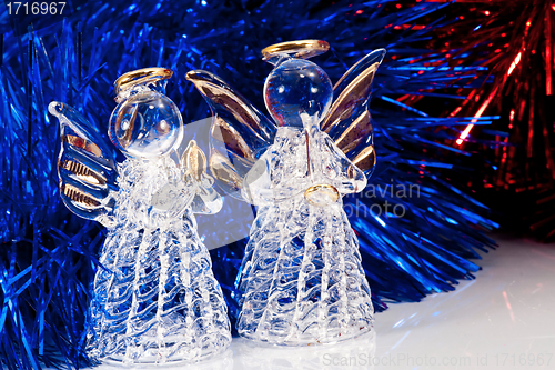 Image of Two glass angel and Christmas tree tinsel