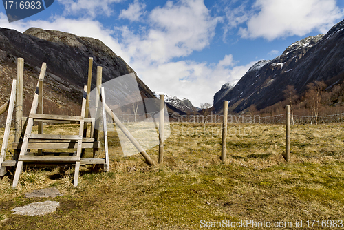 Image of fence with stairs in rural landscape