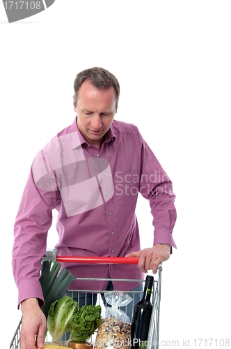 Image of Mature man doing grocery shopping