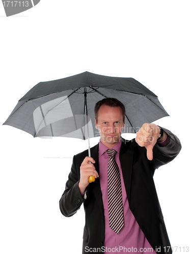 Image of Businessman under umbrella giving a thumbs down