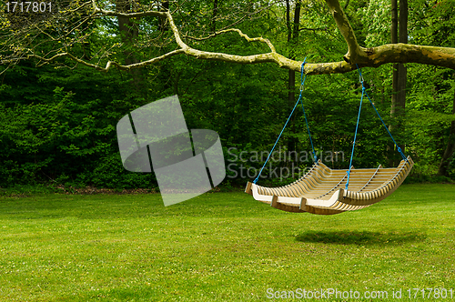 Image of Swing bench in lush garden