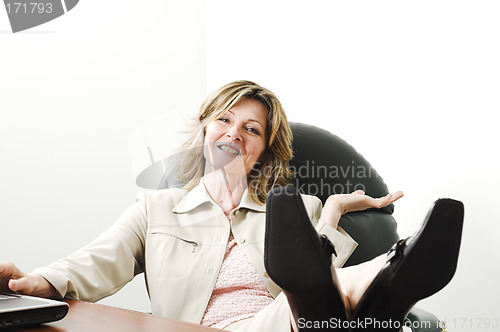 Image of business woman relaxing in board room