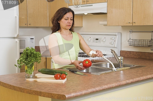Image of woman using faucet